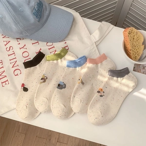 Detailed view of colorful cartoon animal embroidery on cute dot pattern ankle socks