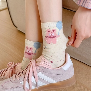 Cute beige crew socks with balloon bear pattern and scalloped trim shown with sneakers