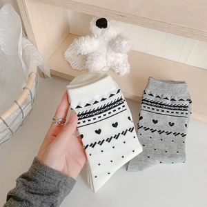 Detail of ribbed knit crew socks with bohemian patterns and soft cotton texture