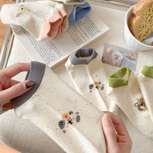 Detail shot of cute cartoon cotton ankle socks with colorful polka dots and contrasting cuffs