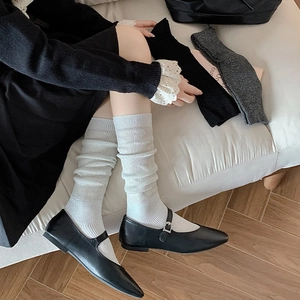 Detailed knit texture of ballet style calf socks in white, black and dark grey colors