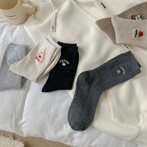 Detailed view of Japanese style mid-calf socks with cute fruit and letter embroidery