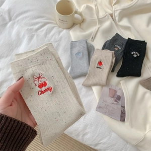Detailed embroidery of cherry and coffee patterns on colorful point yarn socks