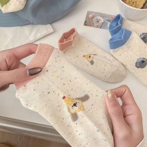 Detail showing elastic rib cuff and cute cartoon dog pattern on cotton ankle socks