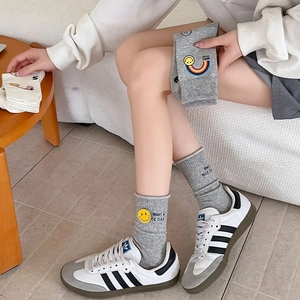 Detail view of cotton socks with rainbow smiley embroidery and ribbed cuffs