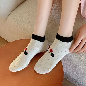 Close-up of knit cotton socks with colorful dots and a cute cartoon puppy design