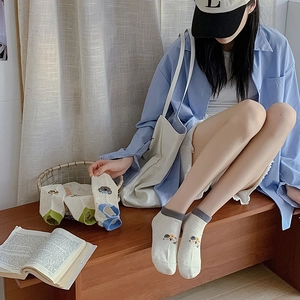 Detail shot of cute cartoon ankle socks with contrast colors on a lifestyle background
