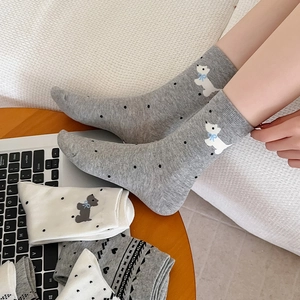 Detail of cotton crew socks featuring cute puppy embroidery and polka dot patterns
