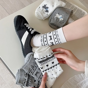 Close-up of cute dog and bow patterns on cotton crew socks in white and grey