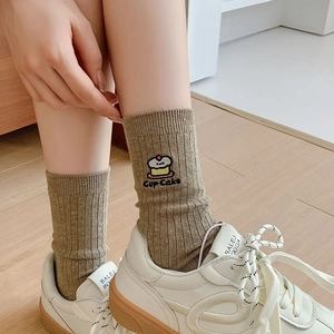 Detailed close-up of cupcake embroidery on khaki ribbed cotton crew socks for women