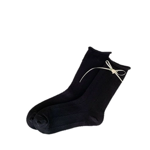 Sweet black mid-calf socks with cream ribbon bow and small flower detail in knit cotton