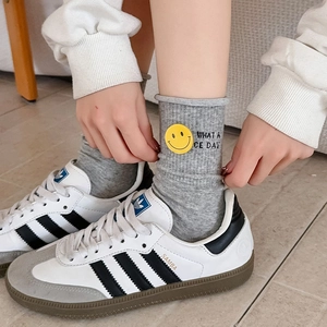Grey ribbed socks featuring a yellow smiley face patch and custom letter embroidery
