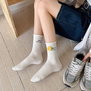 White crew socks with smiley face badge and WHAT A NICE DAY slogan for casual wear