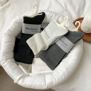 Detailed set of three shimmering calf socks in black, beige, and grey with fine glitter