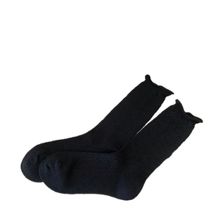 Breathable black knit crew socks with vintage lettuce edge cuffs on white background
