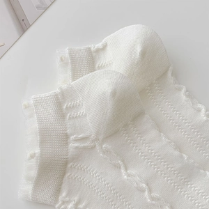 Detailed view of white cotton ankle socks with hollow lace trim and vertical stripes