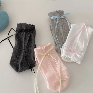 Detail of sweet JK style socks with ribbon bows and ruffled cuffs in four pastel colors