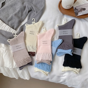 Detailed close-up of ribbed cotton mid-calf socks in six assorted soft pastel colors