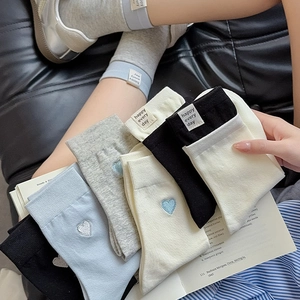 Close-up of cotton crew socks with heart embroidery and 'happy every day' label detail
