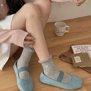 Sweet blue Mary Jane shoes and gray ruffled socks with pink heart embroidery details