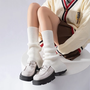 White ribbed knit leg warmers paired with platform loafers and academy style outfit