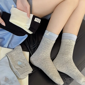 Detail showing high-quality cotton socks with happy every day label and heart embroidery