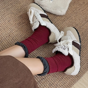 Women's autumn fleece sneakers with khaki suede and red knit socks on woven rug