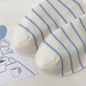 Close-up of high-quality knit texture and seamless toe of white striped cotton socks