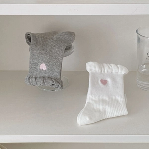 Detail of grey and white socks with pink heart embroidery and ribbed elastic cuffs
