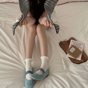 Blue suede Mary Janes paired with white frill socks for a Japanese aesthetic style