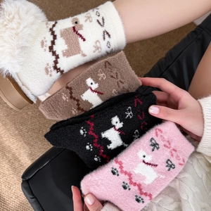 Detailed close-up of thick thermal coral fleece socks with cute cartoon puppy patterns