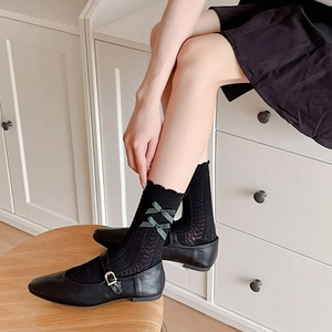 Chaussettes noires style ballet avec motifs nœuds verts et élégante bordure dentelle