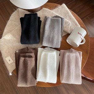 Detailed view of ribbed knit leg warmers in five vintage colors for autumn and winter