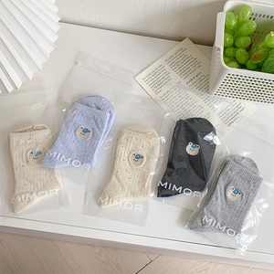 Detail of five-pair set crew socks with cute bear embroidery in frosted zip bags