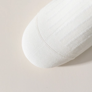 Detailed macro view of white ribbed knit fabric toe stitching on soft cotton socks