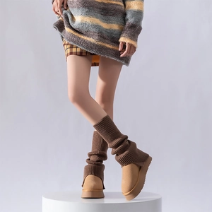 Detail of camel suede boots with brown ribbed knit sock cuffs and platform sole