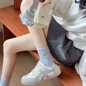 Close-up of cute bear embroidery on soft cotton mid-calf socks in various colors