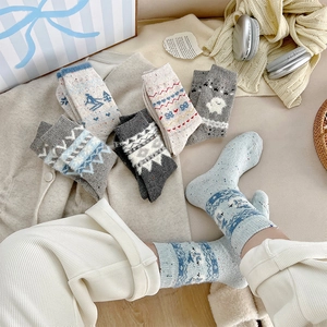Close-up of thick wool socks with Nordic Fair Isle patterns and cozy ribbed cuffs