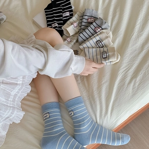 Striped mid-calf cotton socks with struggle label in various colors shown on model