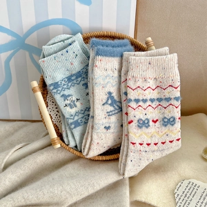 Close-up of Fair Isle knit wool socks with festive patterns in a woven basket