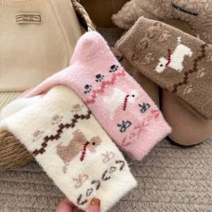 Close-up of thick plush socks featuring cute dog patterns in cream, pink, and mocha brown