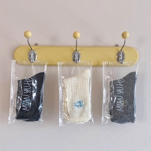 Three pairs of cotton crew socks with 'Be Nice' embroidery in transparent zip bags