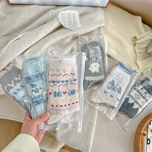 Detailed knit texture of Fair Isle wool socks with premium individual zipper packaging