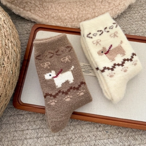 Detailed view of thick fuzzy puppy socks in brown and cream with cute bow patterns