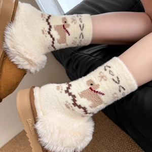 Detail of plush cream socks with cartoon puppy patterns and fluffy faux fur trim