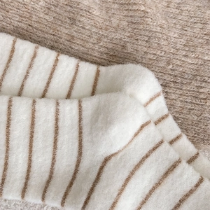 Close-up of thick thermal striped wool socks with soft fluffy texture and warm lining