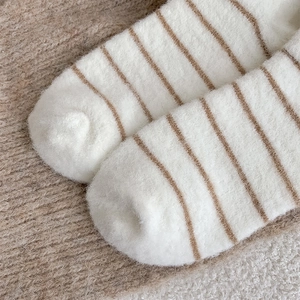 Close-up of thick striped thermal fleece socks with soft plush texture for winter