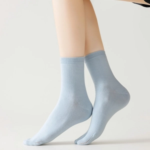 Detail of light blue Tabi split-toe cotton socks showing ribbed cuffs and breathable knit