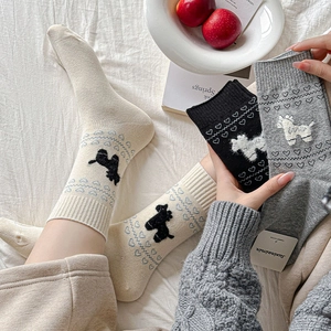 Close-up of knit heart pattern and cute 3D animal patch detail on mid-calf socks