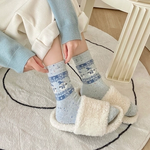 Fair Isle knit wool socks in light blue with snowman pattern and ribbed cuffs for winter